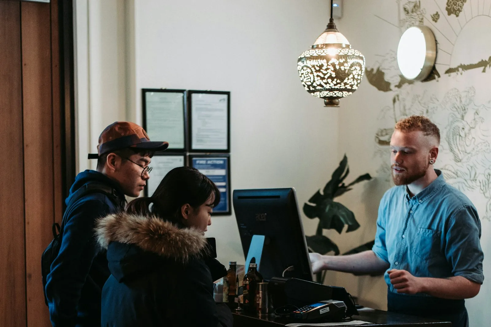 Guests checking in at a hotel front desk